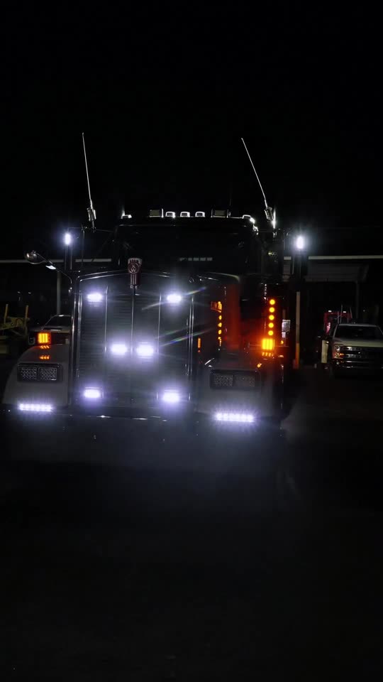 Semi trucks lit up at night