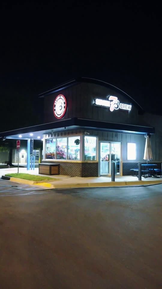 7 Brew coffee stand lit up during a night wash