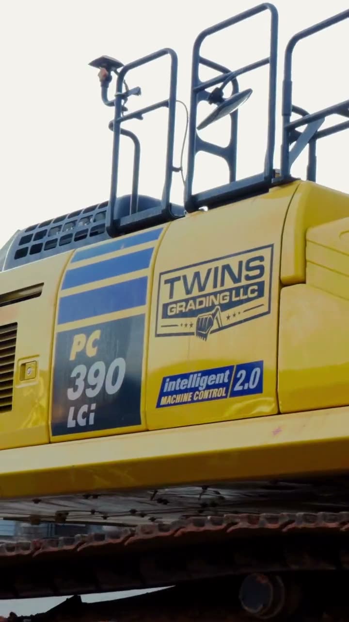Twins Grading excavator loaded on a trailer