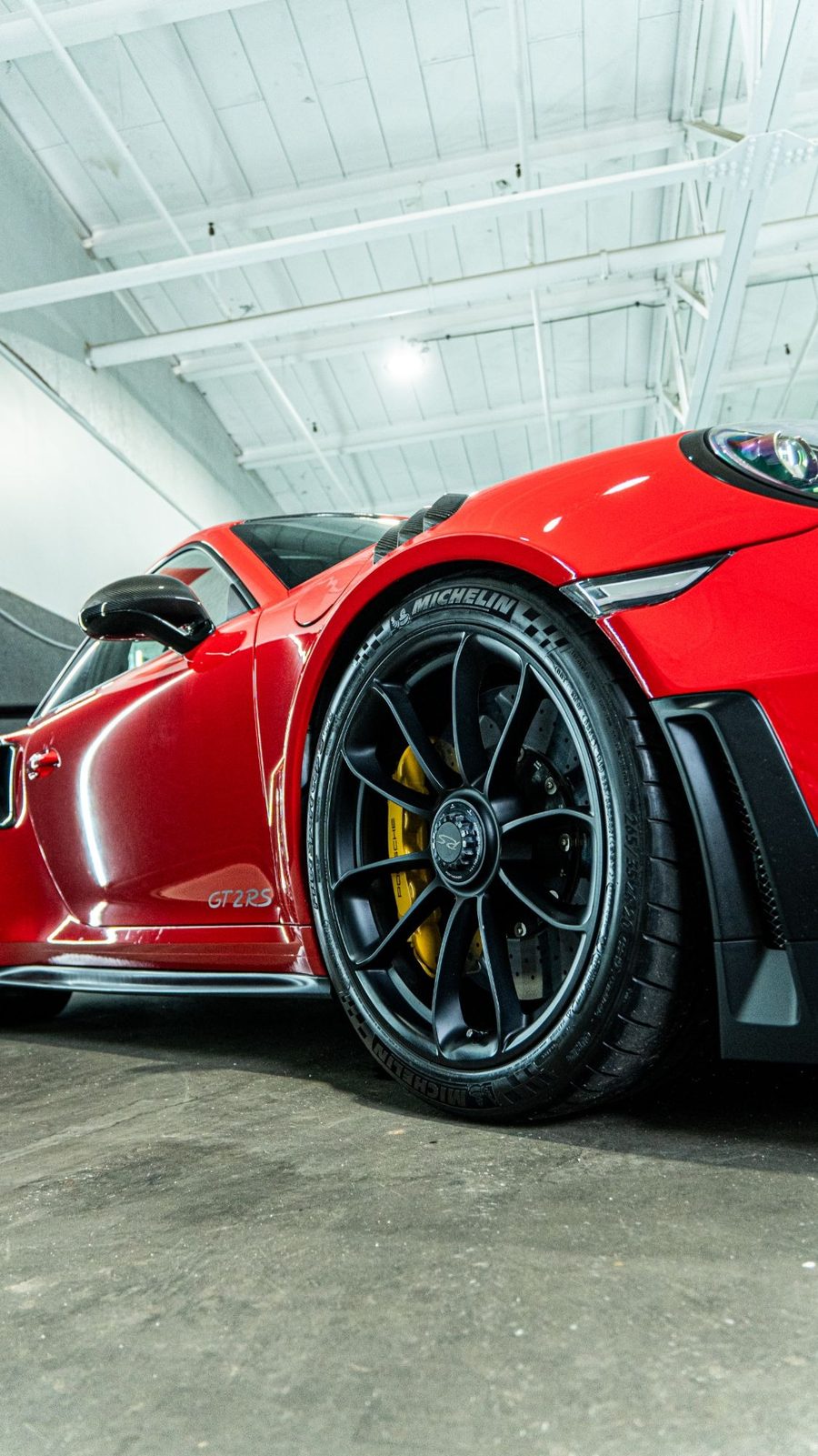 Wheel and yellow caliper on a red Porsche GT2 RS