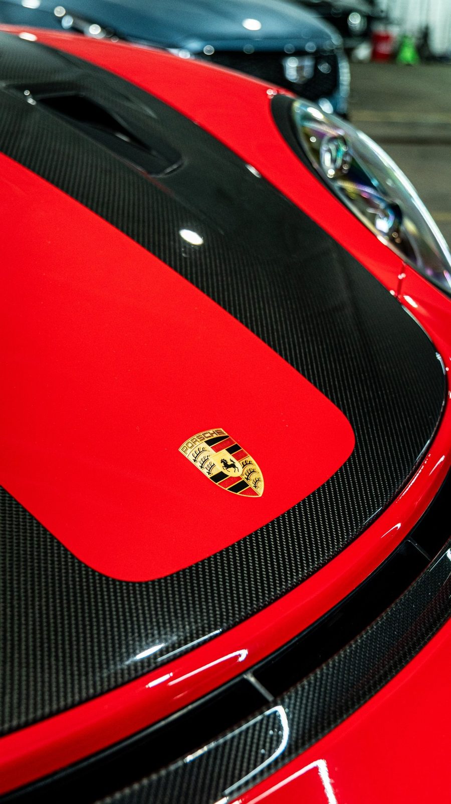 Porsche crest on a carbon fiber hood
